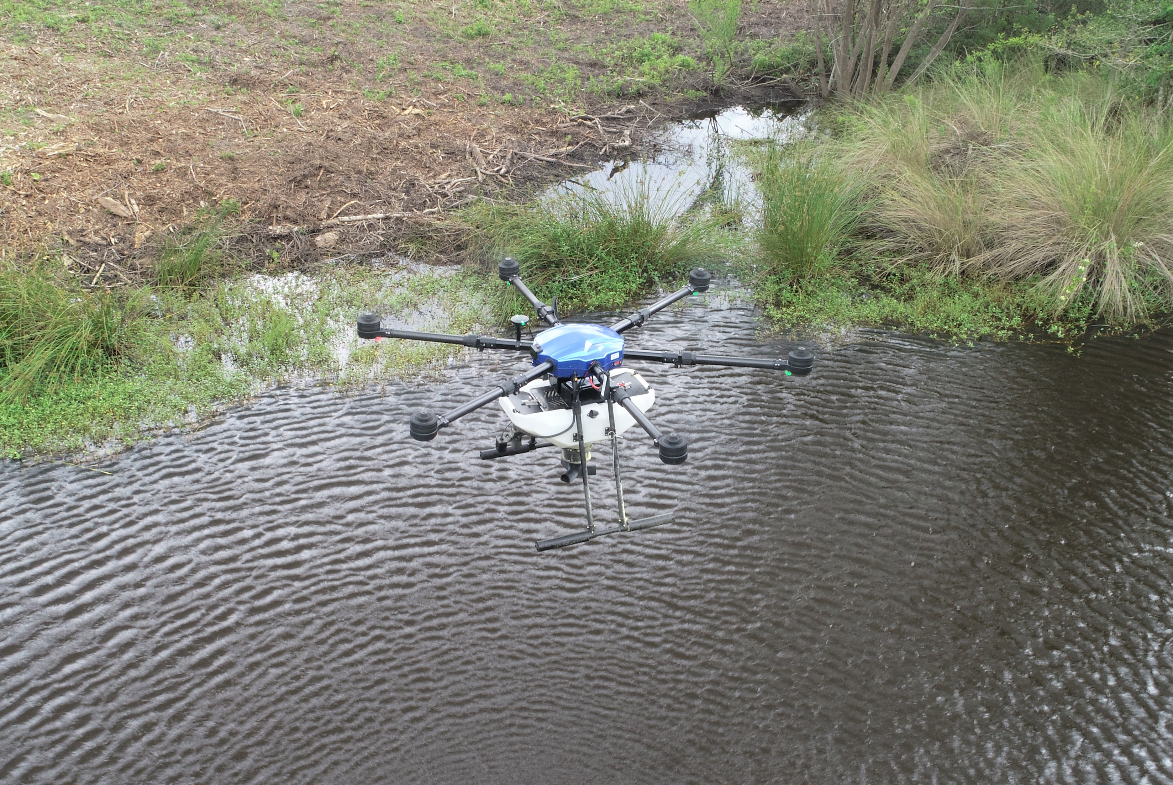 A drone applies mosquito larvicide in Florida.