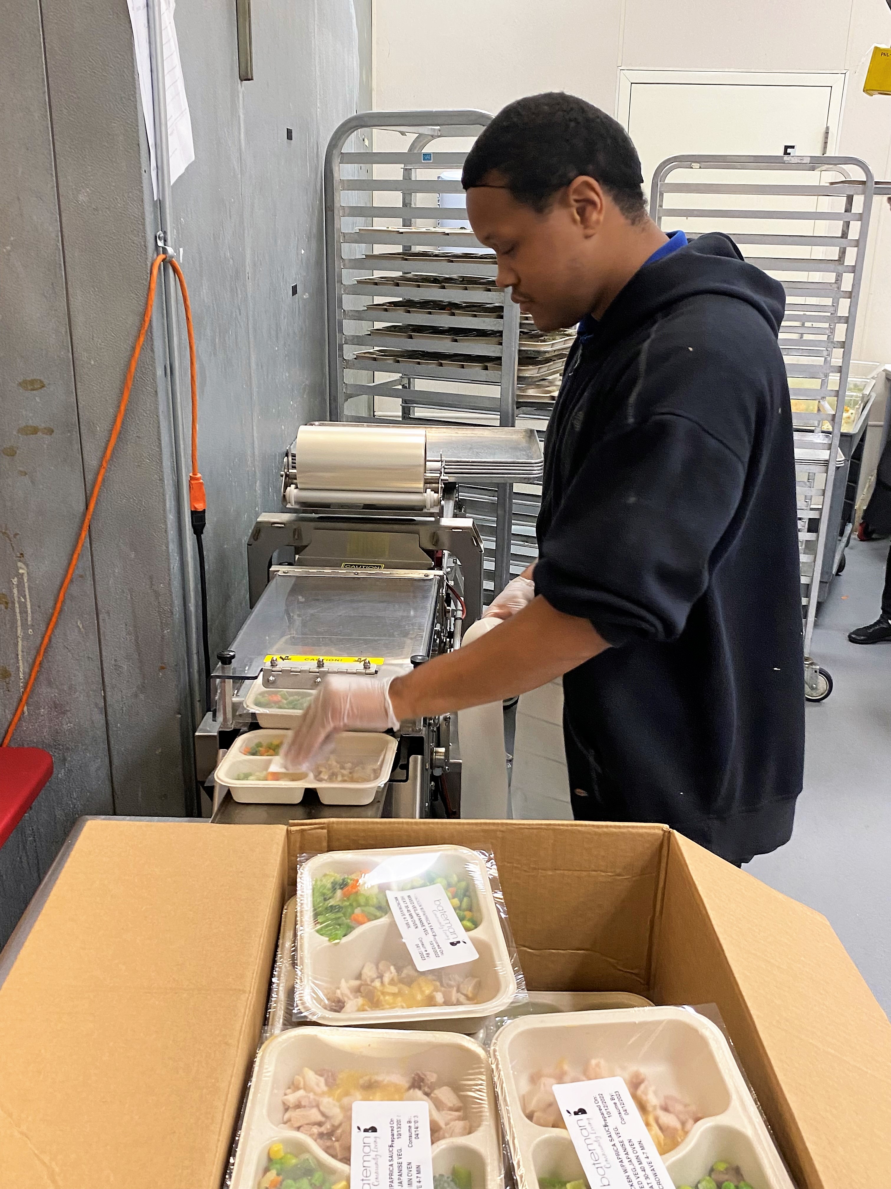 Marquez Robinson in Trio's kitchen prepping food for weekly Meals on Wheels deliveries