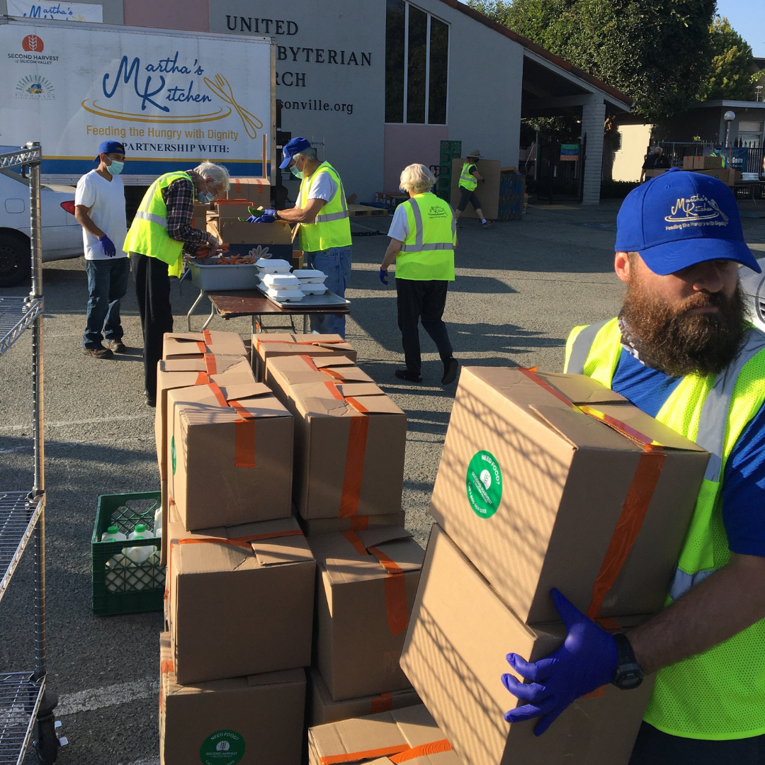 Volunteers hand out grocery boxes at nonprofit Martha's Kitchen in San Jose.
