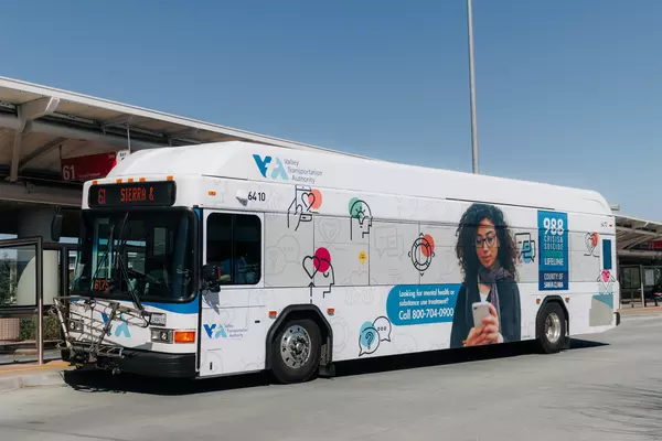 A VTA bus is seen wrapped with images promoting the 988 mental health hotline.