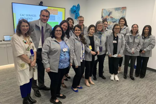 Staff of the Children's Advocacy Center and the County of Santa Clara District Attorney's Office pose for a picture inside the center during a one-year celebration of its opening.