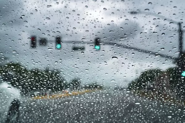 Photo of rain through a car windshield.
