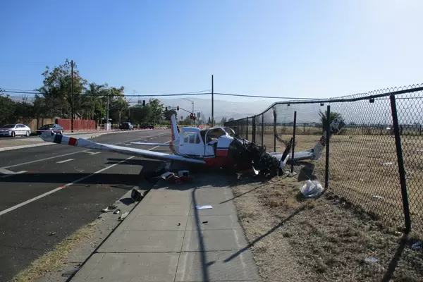 A Piper single-engine airplane is on the road beside Reid-Hillview Airport in San Jose after a July 2022 crash.