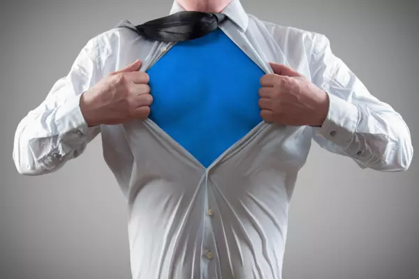 man opening shirt to reveal superhero blue underneath