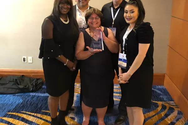 The DCSS team with their award (L to R): Regina Martin, recently retired Deputy Director, Director Ignacio J. Guerrero, Legal Division Manager Stacy Thurber, Deputy Director Don Semon, and Management Analyst Leila Ochoa.