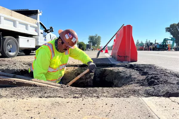 Contruction worker digs a hole along Almaden Expressway.