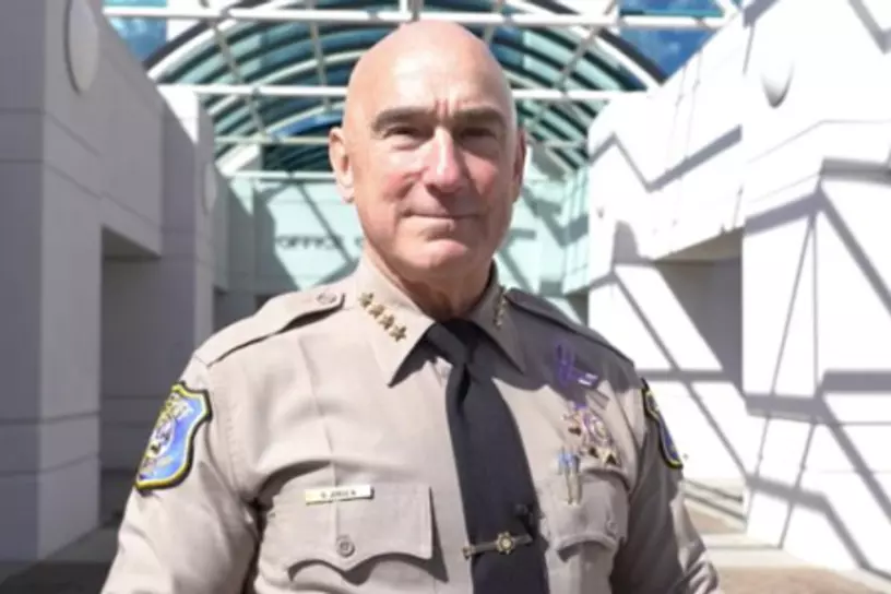 Man in sheriff uniform smiling at camera