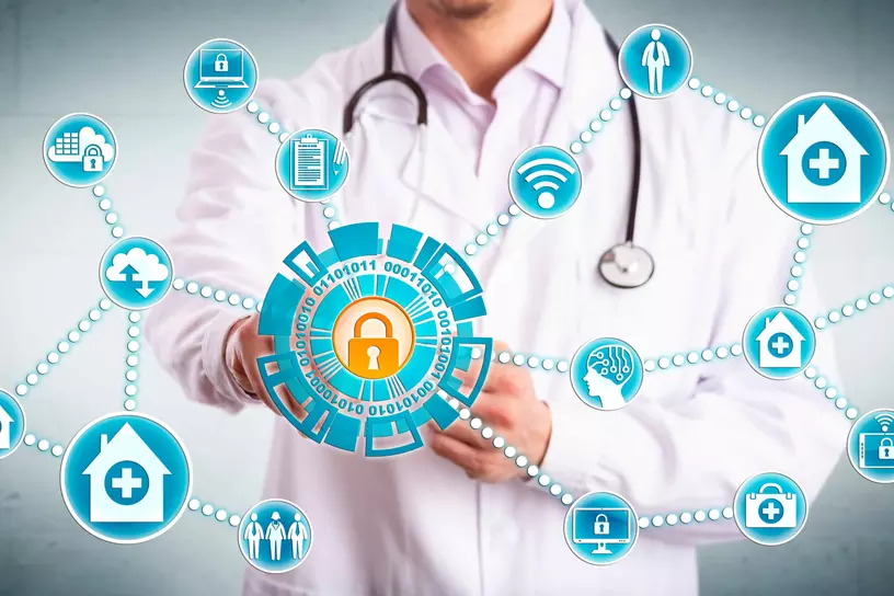 Young male clinician securely sharing sensitive healthcare data across mobile devices and medical practices. IT concept for cybersecurity and secure information sharing in the health care industry