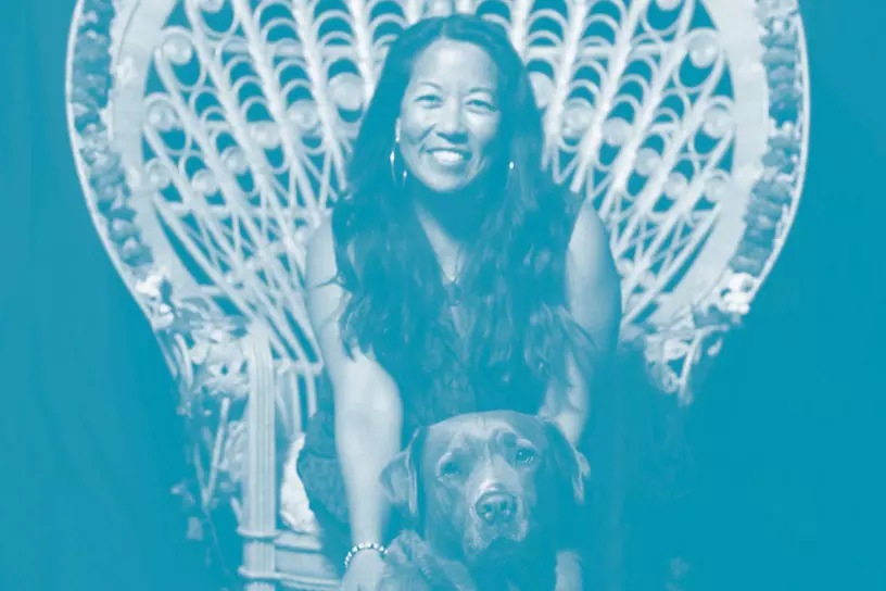 Arlene Biala - sitting in chair with dog, brown lab - aapi month graphic