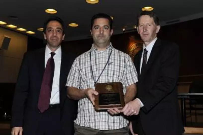 Chris Corpora receiving the Lowell W. Bradford Achievement of Excellence Award for Crime Lab Division