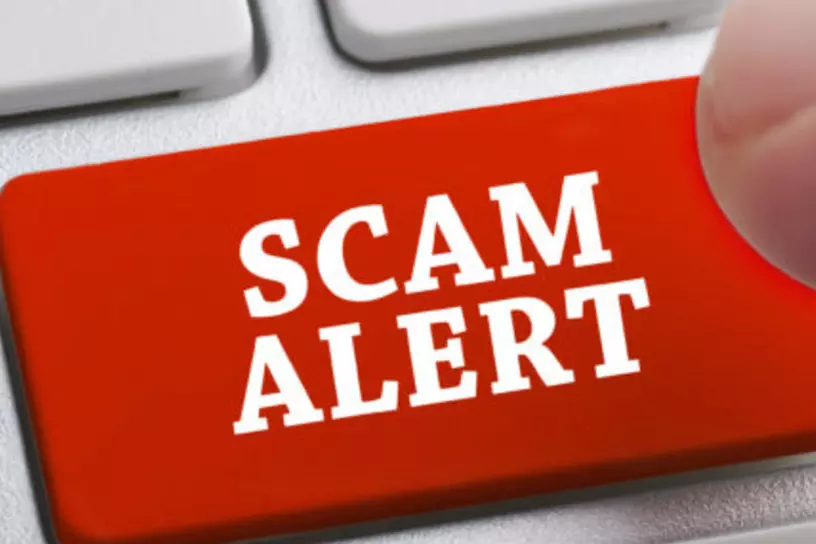 a keyboard button that says, "scam alert."