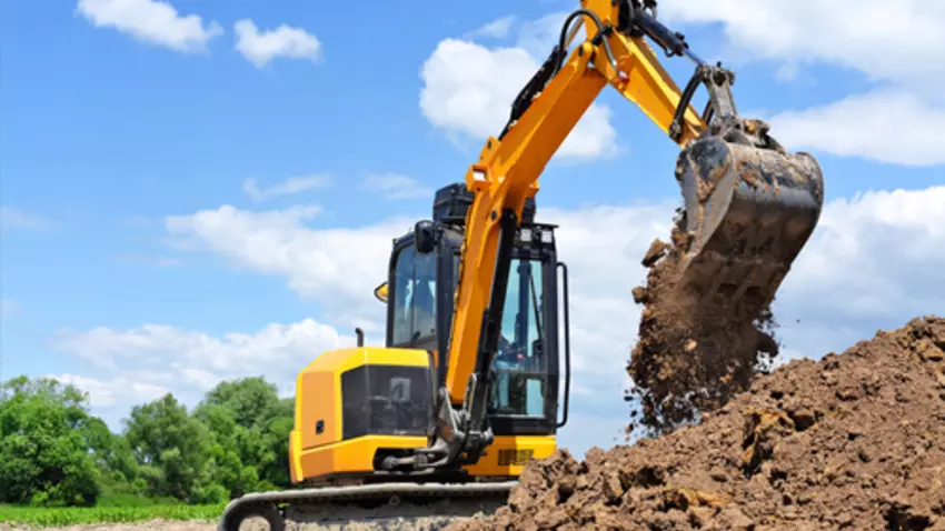 An excavator digging dirt on a construction site