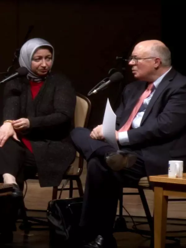 Joe on stage moderating a panel on Understanding Islam with two panelists on his right.