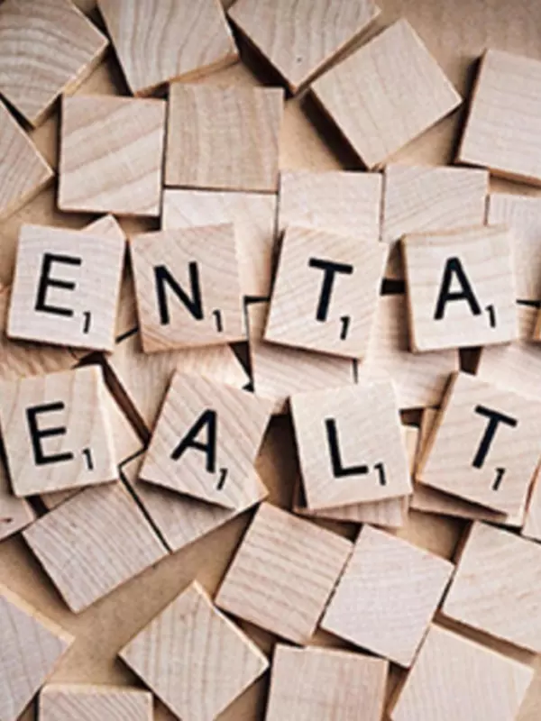 Image of scrabble-style wooden letter blocks spelling out "Mental Health".
