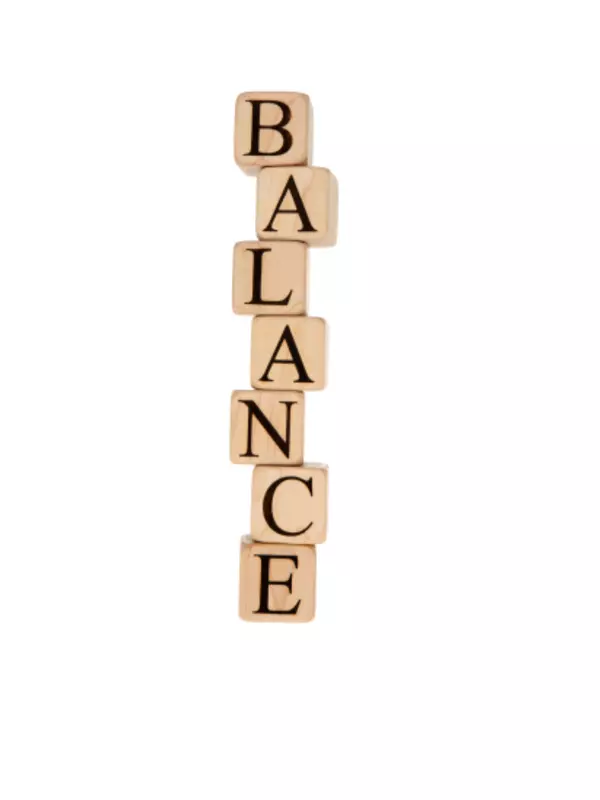 Alphabet block stacked vertically to spell 'balance.'