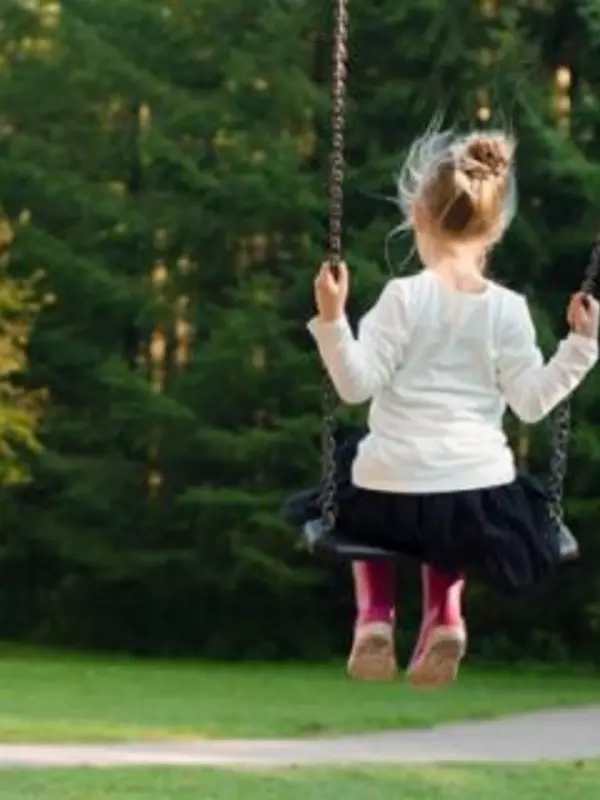 little girl on a swing