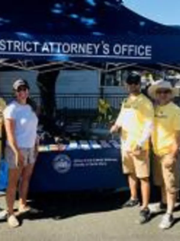 District Attorney Office members standing by their tent station