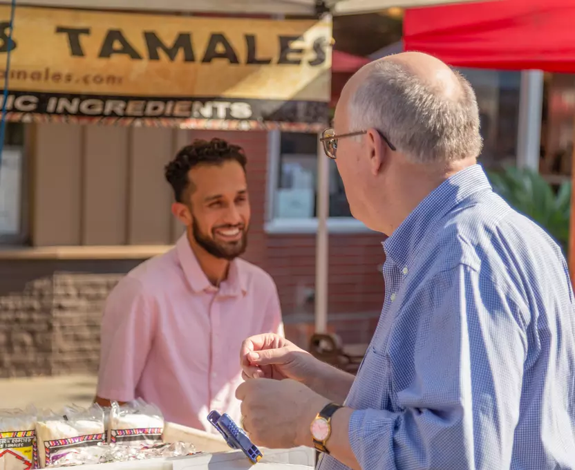 Joe Simitian talking with a tamale vendor