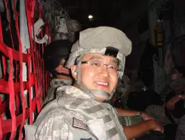 man in military uniform smiling at camera