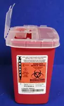 Red plastic sharps container with its lid popped open and biohazard sticker on the container's front.
