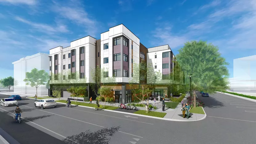 A computer rendering of the new housing project on Grant Avenue. A 3-story white building with bicycle parking, people walking sidewalks, plenty of trees, and a couple of cars.