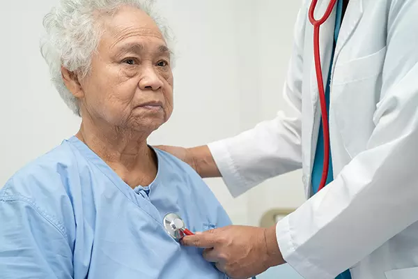 Doctor examining a female elder
