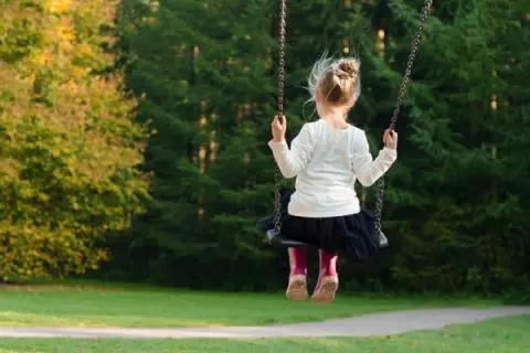 little girl on a swing