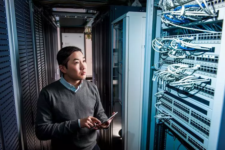 Tech employee at a computer server rack