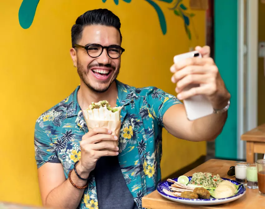 Man eating health food and taking selfie